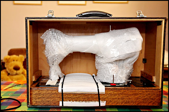 Picture of sewing machine being packed for sending by courier